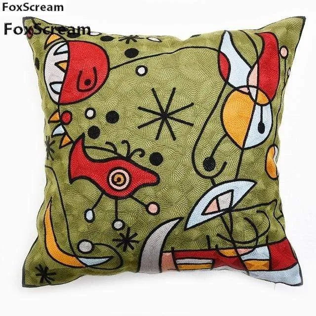 Housse de coussin brodée géométrique